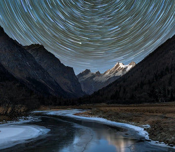 star trails above mountains