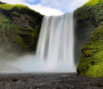 A wide waterfall pouring down the hill